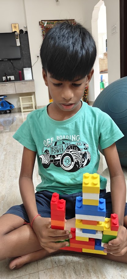 Child building with colorful blocks during a quiet play activity at home