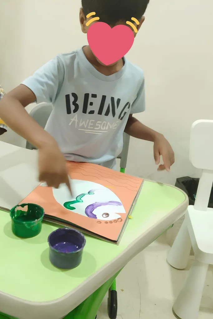 Child painting during a creative learning activity.
