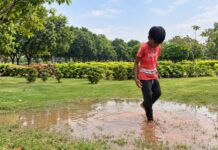 Part 4: Understanding Sensory Processing, Stimming & Behaviour in Autism Child walking barefoot through a shallow puddle while exploring outdoor sensory experiences.