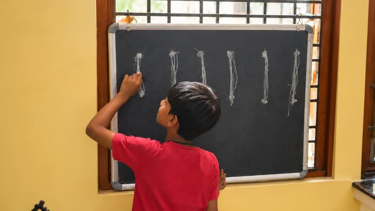 Child working at a home chalkboard during a learning activity