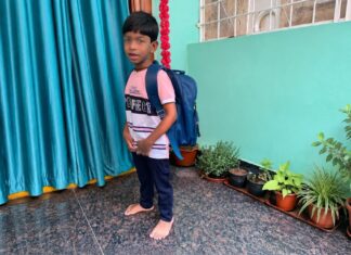 Part 6: Daily Life with Autism – Sleep, Feeding, School & Routines Child wearing a school backpack while getting ready for school as part of a daily morning routine at home.