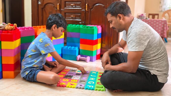 Early Autism Signs Parents May Notice Father sitting with his child during a learning activity at home