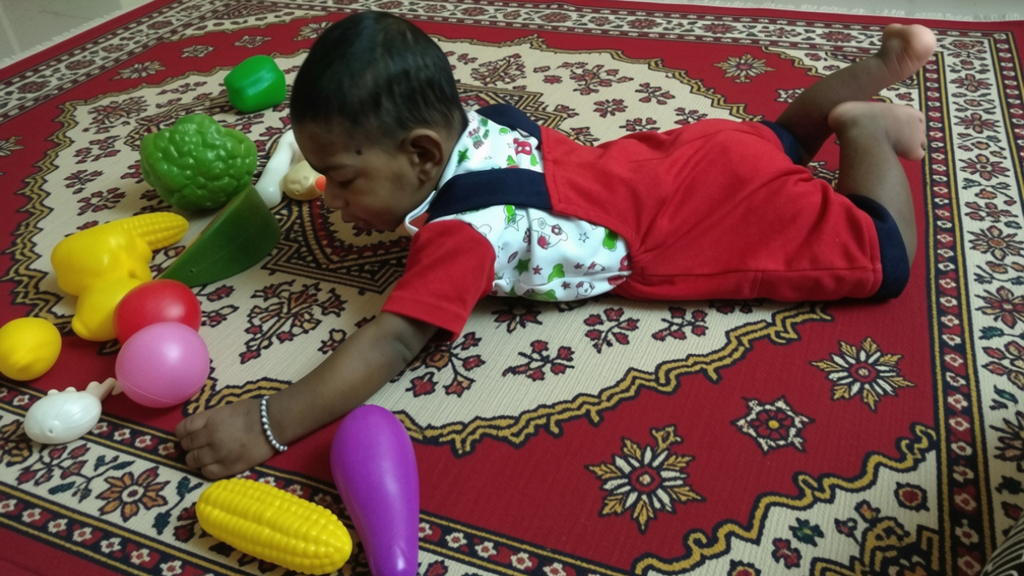 Toddler playing independently with educational toys during early childhood development.