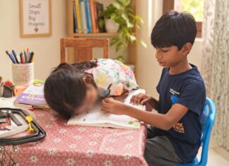 Part 3: Autism Communication – Speech, Language & Connection Siblings sharing a learning activity together using a workbook at home.