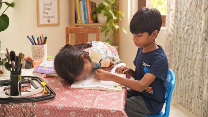 Learning Together Through Everyday Interaction Siblings sharing a learning activity together using a workbook at home.